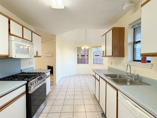 8631 Mapletwist St, Houston, TX 77083 - kitchen featuring white appliances, a sink, light countertops, a textured ceiling, and a chandelier