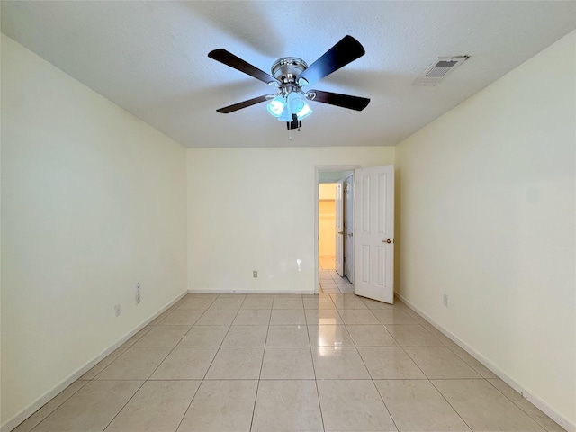 8631 Mapletwist St, Houston, TX 77083 - empty room featuring ceiling fan, light tile patterned floors, baseboards, and a textured ceiling