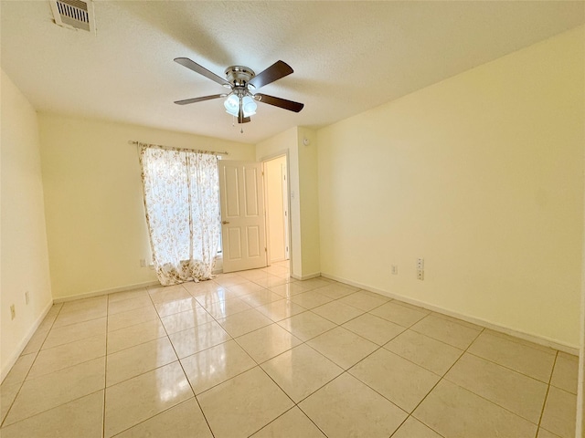 8631 Mapletwist St, Houston, TX 77083 - empty room featuring ceiling fan, light tile patterned floors, baseboards, and a textured ceiling