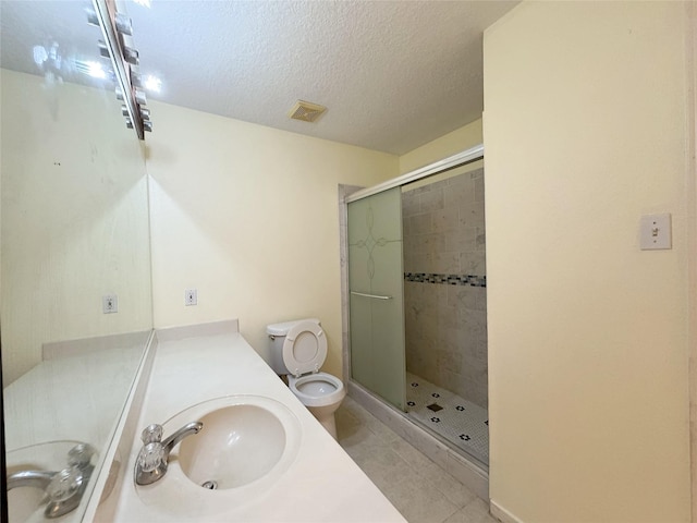 8631 Mapletwist St, Houston, TX 77083 - full bath featuring toilet, a shower stall, tile patterned floors, vanity, and a textured ceiling