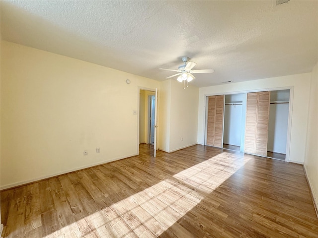 8631 Mapletwist St, Houston, TX 77083 - unfurnished bedroom featuring wood finished floors, a textured ceiling, baseboards, a ceiling fan, and a closet