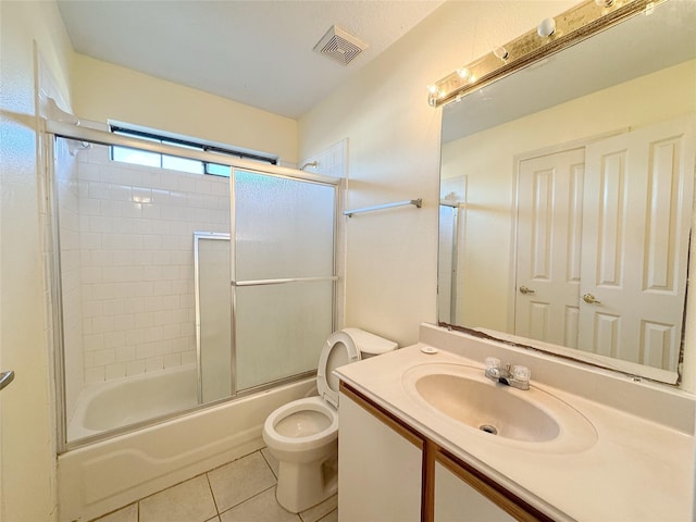 8631 Mapletwist St, Houston, TX 77083 - bathroom featuring toilet, tile patterned floors, vanity, and combined bath / shower with glass door