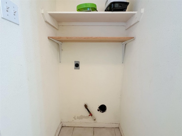8631 Mapletwist St, Houston, TX 77083 - laundry area with electric dryer hookup, tile patterned flooring, and baseboards