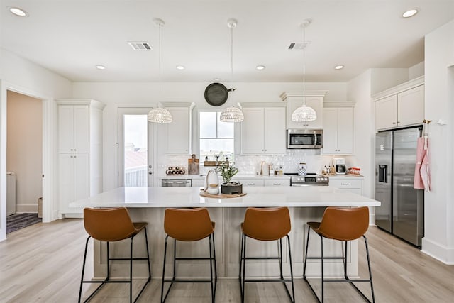 4101 5th St, Galveston, TX 77554 - kitchen with stainless steel appliances, light countertops, white cabinetry, and recessed lighting