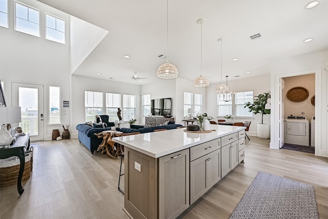 4101 5th St, Galveston, TX 77554 - kitchen featuring light wood-type flooring, a kitchen island, light countertops, recessed lighting, and decorative light fixtures