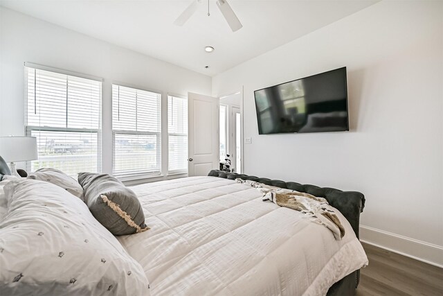 4101 5th St, Galveston, TX 77554 - bedroom with dark wood-style floors, baseboards, and a ceiling fan