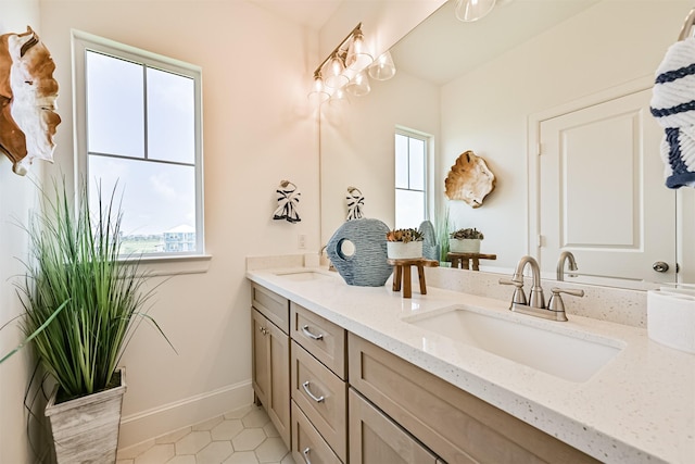 4101 5th St, Galveston, TX 77554 - bathroom with plenty of natural light, double vanity, and tile patterned flooring