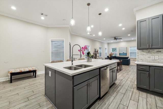 314 E 40th St, Houston, TX 77018 - kitchen with stainless steel dishwasher, a sink, gray cabinets, light countertops, and recessed lighting