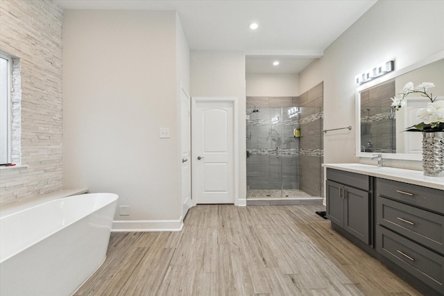 314 E 40th St, Houston, TX 77018 - bathroom featuring a stall shower, vanity, wood finished floors, a freestanding bath, and baseboards