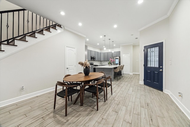314 E 40th St, Houston, TX 77018 - dining room featuring crown molding, baseboards, light wood-style floors, recessed lighting, and stairway
