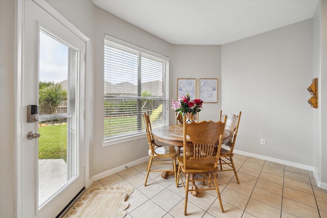 9110 Kinnel Ln, Tomball, TX 77375 - dining area featuring baseboards and light tile patterned flooring