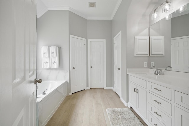 9110 Kinnel Ln, Tomball, TX 77375 - full bath with ornamental molding, a bath, vanity, wood finished floors, and a closet