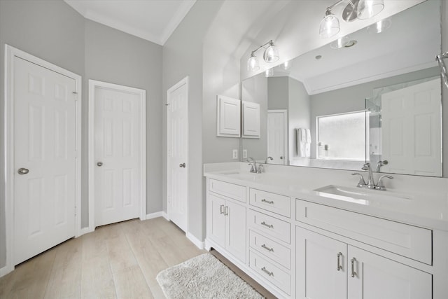 9110 Kinnel Ln, Tomball, TX 77375 - full bath featuring double vanity, wood finished floors, and baseboards
