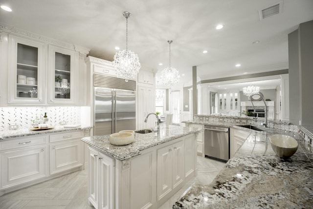 10887 Decatur St, Willis, TX 77318 - kitchen with stainless steel appliances, a chandelier, decorative backsplash, recessed lighting, and white cabinets