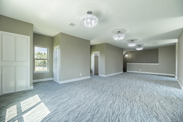 10887 Decatur St, Willis, TX 77318 - unfurnished room with a chandelier, light colored carpet, and baseboards