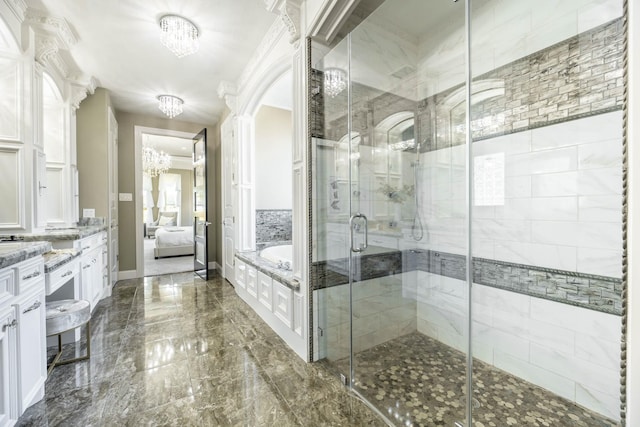 10887 Decatur St, Willis, TX 77318 - ensuite bathroom featuring a bath, vanity, a chandelier, marble tiled flooring, and a shower stall
