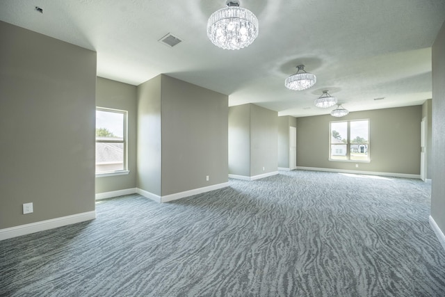 10887 Decatur St, Willis, TX 77318 - unfurnished room featuring a chandelier, carpet flooring, and baseboards