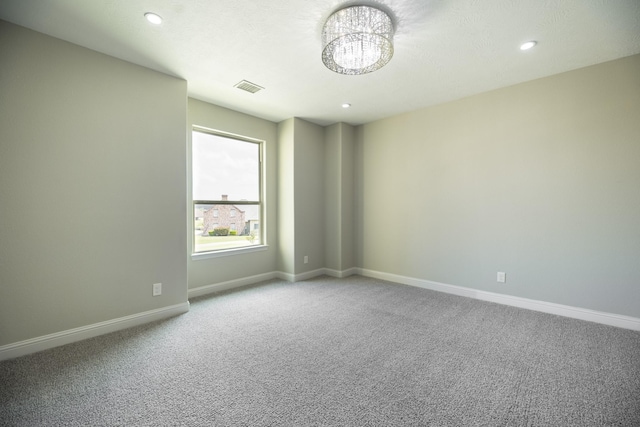 10887 Decatur St, Willis, TX 77318 - empty room featuring baseboards, carpet flooring, a chandelier, and recessed lighting