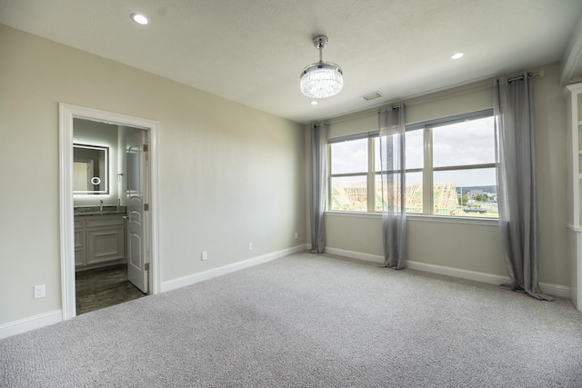 10887 Decatur St, Willis, TX 77318 - unfurnished bedroom featuring carpet, recessed lighting, baseboards, and ensuite bath