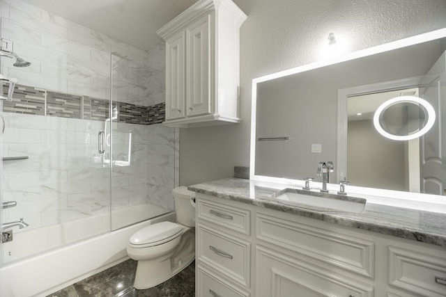 10887 Decatur St, Willis, TX 77318 - full bath featuring toilet, vanity, shower / bath combination with glass door, and marble finish flooring
