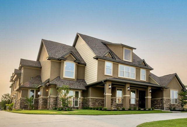 10887 Decatur St, Willis, TX 77318 - view of front of house with stucco siding, stone siding, and curved driveway