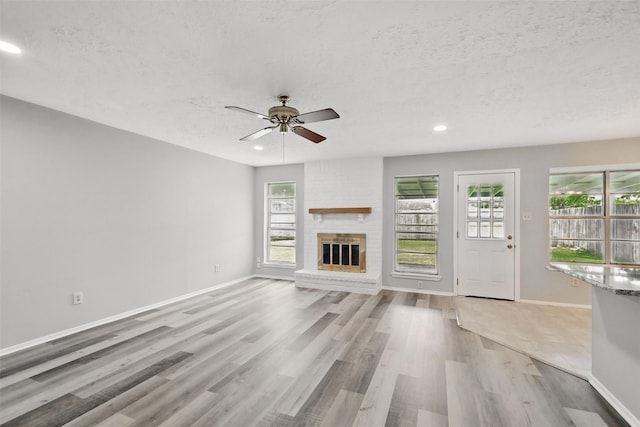 10119 Peachridge Dr, Houston, TX 77070 - unfurnished living room featuring a ceiling fan, light wood-style flooring, a textured ceiling, baseboards, and recessed lighting