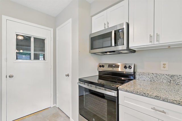 10119 Peachridge Dr, Houston, TX 77070 - kitchen featuring stainless steel appliances, light stone counters, and white cabinets