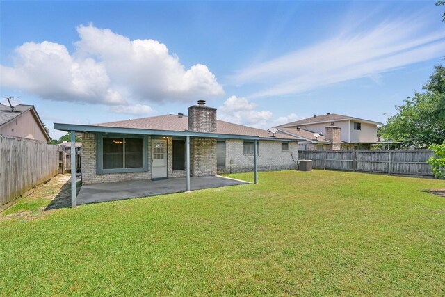 10119 Peachridge Dr, Houston, TX 77070 - back of property featuring a chimney, a patio area, and brick siding