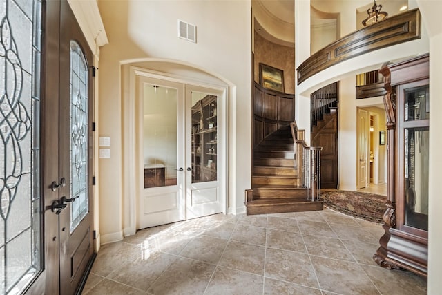 13803 Oak Fair Bnd, Cypress, TX 77429 - tiled foyer with french doors, stairs, a towering ceiling, and baseboards