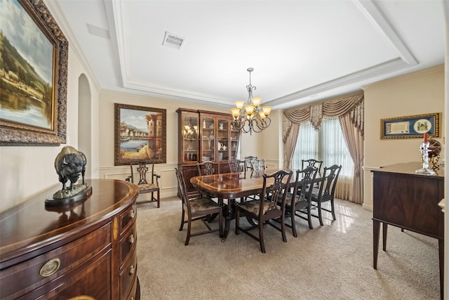 13803 Oak Fair Bnd, Cypress, TX 77429 - dining space with a raised ceiling, light carpet, a chandelier, arched walkways, and ornamental molding
