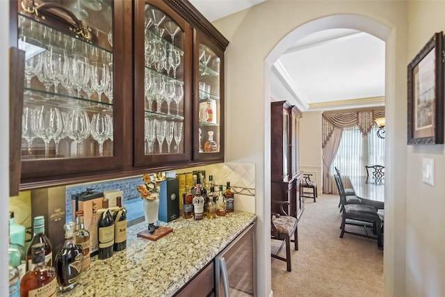13803 Oak Fair Bnd, Cypress, TX 77429 - indoor dry bar with wine cooler, arched walkways, light colored carpet, and a chandelier