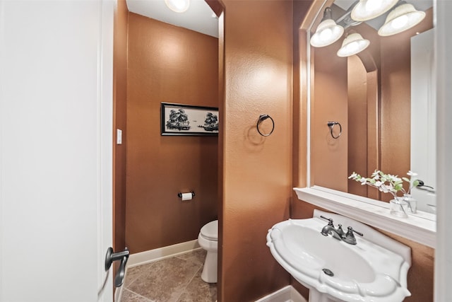 13803 Oak Fair Bnd, Cypress, TX 77429 - half bathroom with a sink, toilet, baseboards, and tile patterned floors
