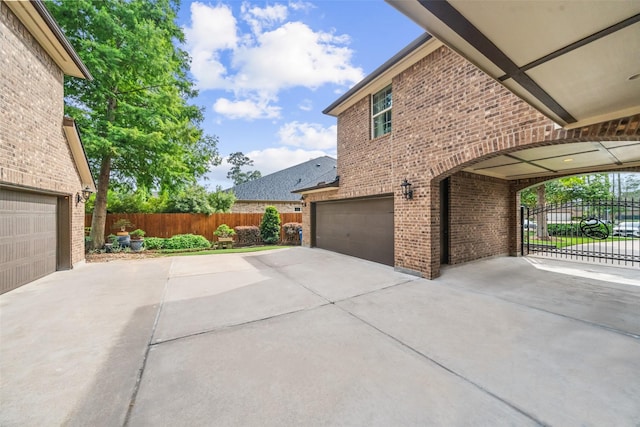 13803 Oak Fair Bnd, Cypress, TX 77429 - view of side of property featuring brick siding, concrete driveway, and an attached garage