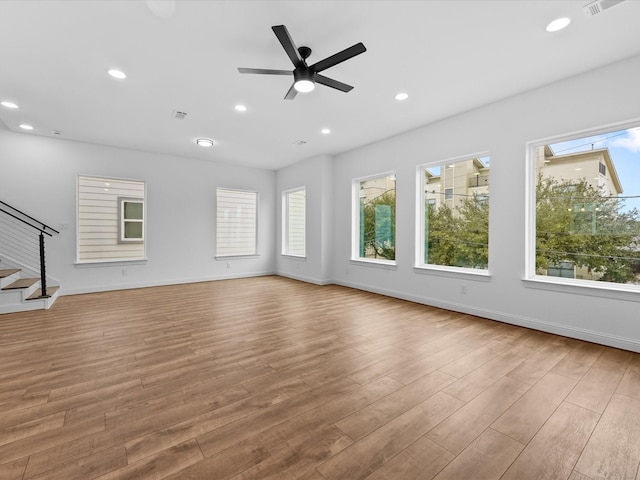 2318 Mcilhenny St, Houston, TX 77004 - unfurnished living room with stairs, wood finished floors, recessed lighting, baseboards, and ceiling fan