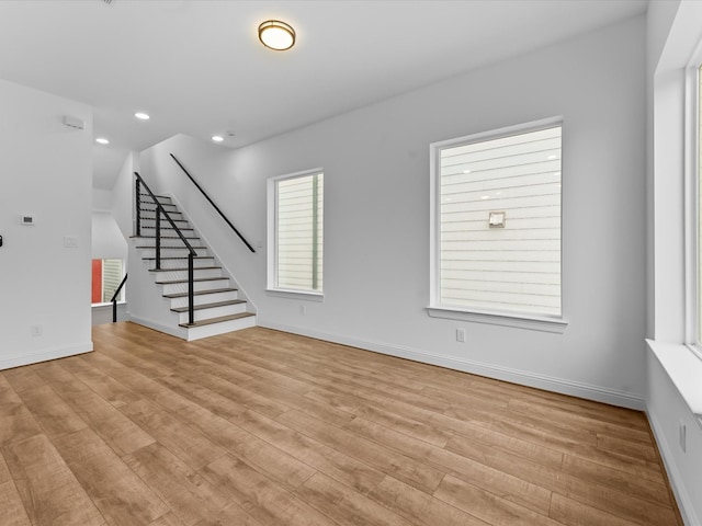 2318 Mcilhenny St, Houston, TX 77004 - unfurnished living room with light wood-style floors, stairway, recessed lighting, and baseboards