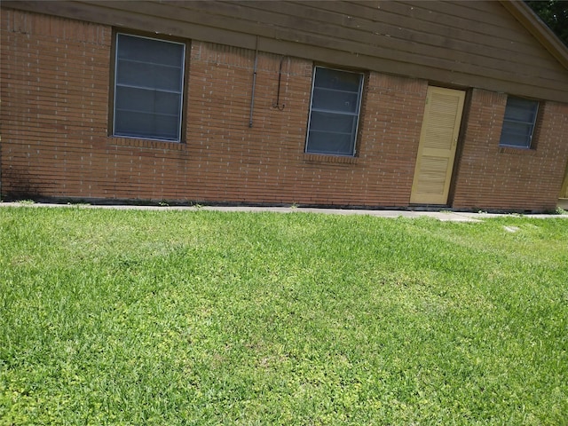 330 Spell St, Houston, TX 77022 - view of property exterior with a yard and brick siding