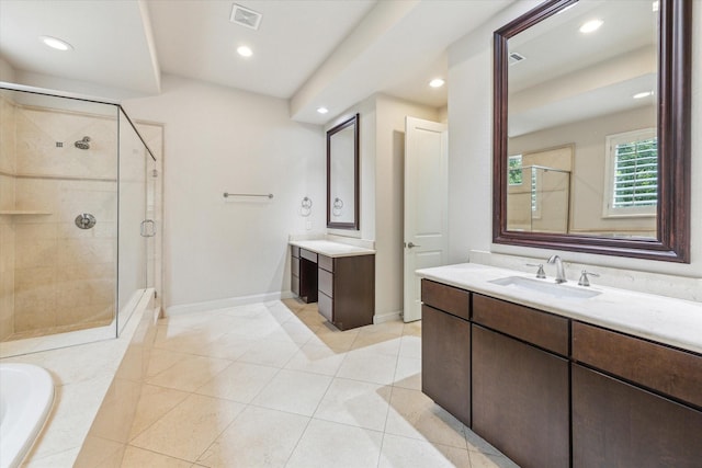 1701 Wrenwood Lks, Houston, TX 77043 - bathroom featuring a stall shower, two vanities, recessed lighting, a bath, and tile patterned floors