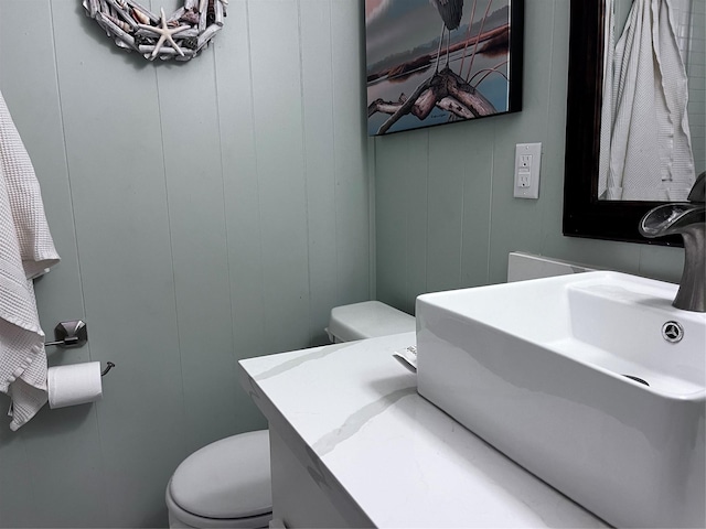 16627 Bermuda Way, Jamaica Beach, TX 77554 - bathroom with toilet, vanity, and a decorative wall
