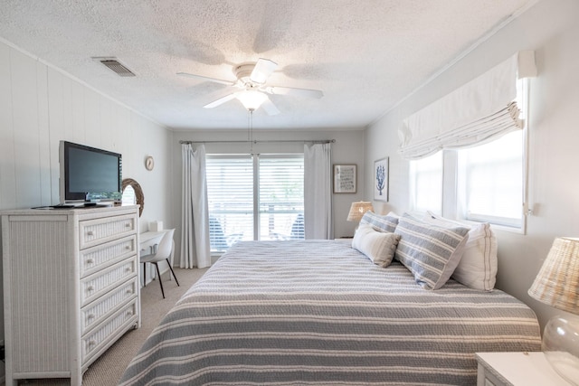 16627 Bermuda Way, Jamaica Beach, TX 77554 - bedroom featuring light colored carpet, a textured ceiling, and ceiling fan
