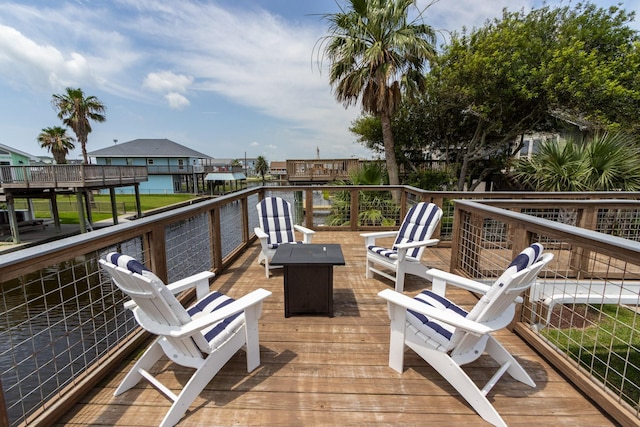 16627 Bermuda Way, Jamaica Beach, TX 77554 - wooden deck featuring an outdoor fire pit