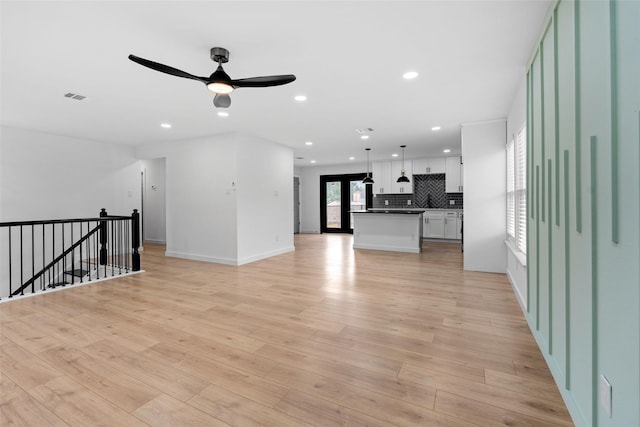 8707 Wind Side Dr, Houston, TX 77040 - unfurnished living room featuring ceiling fan, recessed lighting, light wood finished floors, and baseboards