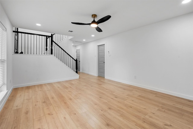 8707 Wind Side Dr, Houston, TX 77040 - unfurnished living room featuring a ceiling fan, stairs, light wood-style flooring, baseboards, and recessed lighting