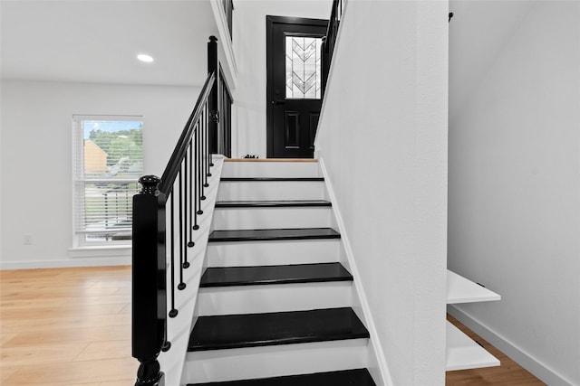 8707 Wind Side Dr, Houston, TX 77040 - stairway with wood finished floors, baseboards, and recessed lighting