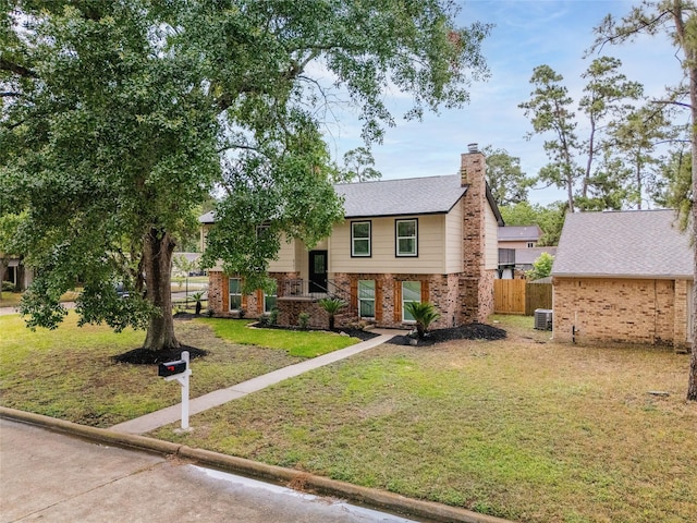 8707 Wind Side Dr, Houston, TX 77040 - bi-level home featuring a chimney, central air condition unit, and brick siding