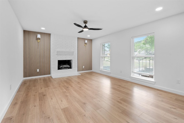 8707 Wind Side Dr, Houston, TX 77040 - unfurnished living room featuring a ceiling fan, a fireplace, light wood-style floors, baseboards, and recessed lighting
