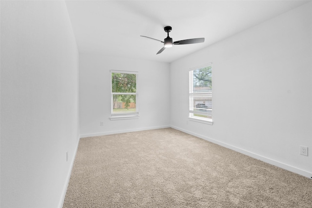 8707 Wind Side Dr, Houston, TX 77040 - spare room with healthy amount of natural light, baseboards, a ceiling fan, and light colored carpet