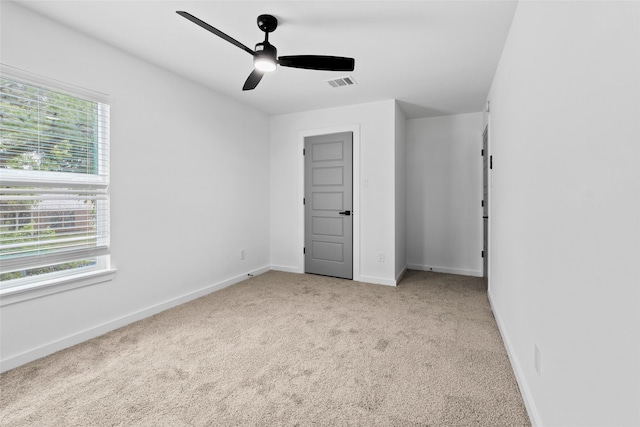 8707 Wind Side Dr, Houston, TX 77040 - unfurnished bedroom with multiple windows, carpet flooring, baseboards, and ceiling fan