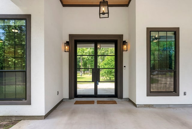 15086 Dewberry Ln, Conroe, TX 77302 - view of exterior entry with french doors and stucco siding