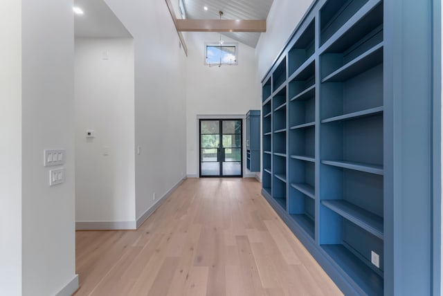 15086 Dewberry Ln, Conroe, TX 77302 - corridor featuring light wood-type flooring, french doors, baseboards, a towering ceiling, and arched walkways