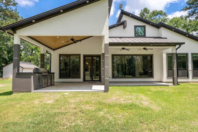 15086 Dewberry Ln, Conroe, TX 77302 - rear view of property with a ceiling fan, a standing seam roof, a patio, and stucco siding